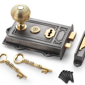 May include: A cast iron door lock set with a brass knob, keyhole cover, and strike plate. Includes two brass keys and black screws. The lock has a decorative design and a vintage aesthetic.