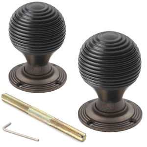 May include: Two antique-style door knobs in a dark bronze finish. Each knob has a spherical shape with a grooved texture. A threaded rod and an Allen key are included. Suitable for interior doors.