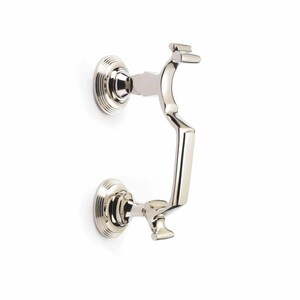 May include: A polished nickel door knocker. The knocker features a curved handle and two circular mounting plates. The design is classic, with a shiny, reflective surface. Ideal for adding elegance to any entrance, it measures approximately 15 cm in length.