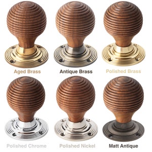 May include: Six wooden door knobs with different metal bases. The knobs have a spherical, grooved design. Finishes include aged brass, antique brass, polished brass, polished chrome, polished nickel, and matt antique. Each knob is labelled with its finish.