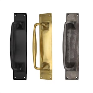 May include: Three door pull handles in different finishes: black, brass, and dark grey. Each has a rectangular backplate and a curved handle. The handles are designed for easy installation and are suitable for various door styles. The brass handle is a bright gold colour.