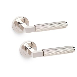 May include: Two polished nickel door handles. Each handle has a circular base, a square connecting section, and a cylindrical, ridged handle. The handles are set against a white background, highlighting their metallic sheen and design.