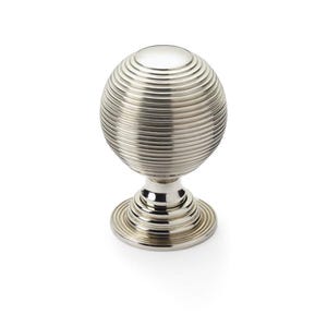 May include: A silver cabinet knob with a spherical, ridged design. The knob sits on a short, tiered base. The hardware is made of metal and is suitable for furniture or cabinetry.