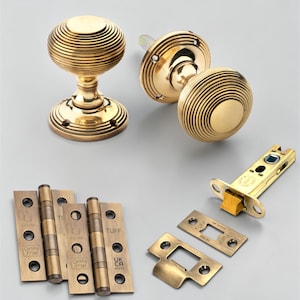 May include: A trio of ceramic mugs with a speckled, matte finish in cream, light grey, and dark grey. Each mug features a minimalist design and a rounded handle. Ideal for tea or coffee.