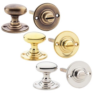 May include: A selection of door knobs and backplates in antique brass, polished brass, and polished nickel. The oval-shaped knobs sit on round bases. The backplates are circular with a slotted screw. Ideal for interior doors.
