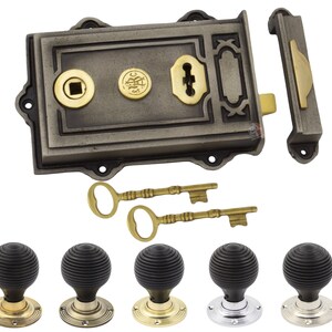 May include: A vintage-style door lock set in dark grey with brass detailing and two skeleton keys. Includes a matching door pull and a selection of black, ribbed door knobs with brass, chrome, and nickel bases.