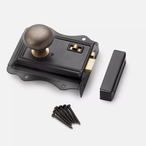 May include: A black door latch with a bronze-coloured knob and a matching strike plate. The latch has a brass-coloured bolt, a separate black strike, and a set of black screws.
