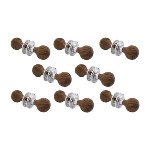 May include: Nine wooden door knobs with a ribbed design. Each knob has a dark brown finish and is mounted on a silver-coloured circular base. The knobs are arranged against a white background.