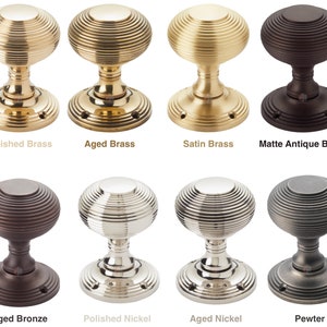May include: Eight door knobs in different finishes: polished brass, aged brass, satin brass, and matte antique brass. Also shown are aged bronze, polished nickel, aged nickel, and pewter. Each knob features a ribbed, spherical design.