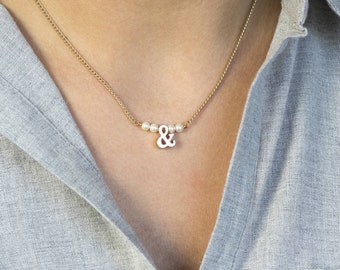 Gold ampersand pearl necklace