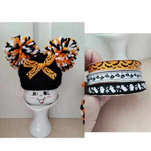 May include: Three rolls of Halloween ribbon with different patterns. The first roll has orange and black bats, the second roll has white bats and black ghosts, and the third roll has white ghosts with the word "Boo" on them.
