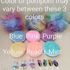 May include: A set of six crocheted circles in various colors, including blue, pink, purple, yellow, peach, and mint. The circles are labeled with the corresponding colors. There are also five small bunny buttons and five small egg buttons with bows.
