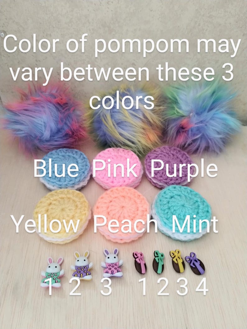 May include: A set of six crocheted circles in various colors, including blue, pink, purple, yellow, peach, and mint. The circles are labeled with the corresponding colors. There are also five small bunny buttons and five small egg buttons with bows.