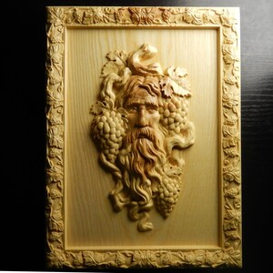 Wood carved picture. Spirit of the wine. Perfect wine room or cellar decoration