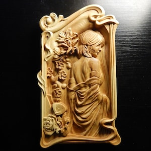 Wood carved picture wall decoration plaque. Young woman in a curved frame. Perfect gift