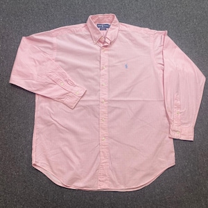 May include: A long-sleeve button-down shirt in a light pink and white gingham check pattern. The shirt features a button-down collar, a front button placket, and a small blue embroidered logo on the left chest. The label reads Ralph Lauren.