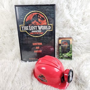 1996 The Lost World Jurrassic Park Framed Promo Poster 17in × 11in combo bundle + helmet + VHS tape
