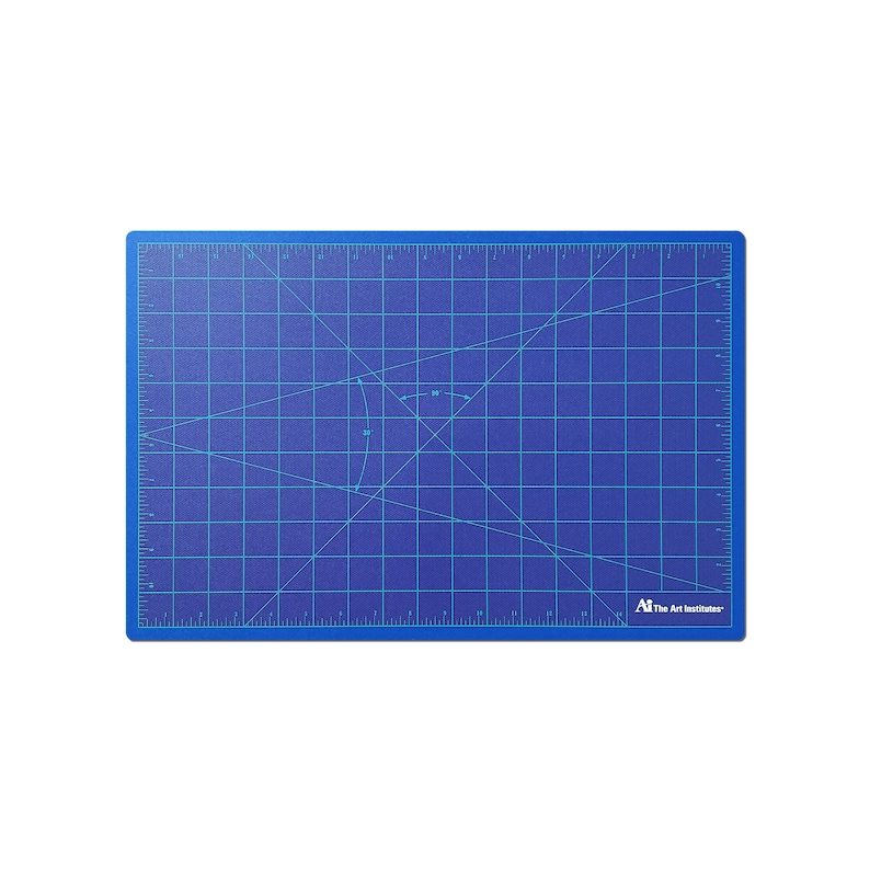 May include: Blue self-healing cutting mat with a grid pattern and ruler markings. The mat has a diagonal line pattern and a small circle with arrows indicating a 45-degree angle. The mat is labeled "The Art Institutes".