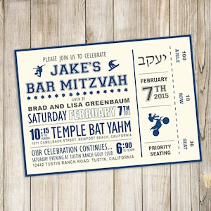 May include: A blue and white ticket-style invitation for a Bar Mitzvah celebration. The invitation features the name "Jake's Bar Mitzvah" in a bold font. The event is scheduled for Saturday, February 7th, 2015, at 10:15 AM at Temple Bat Yahm, 1011 Camelback Street, Newport Beach, California. The celebration continues at 6:00 PM at Tustin Ranch Golf Club, 12442 Tustin Ranch Road, Tustin, California.