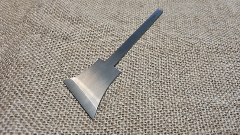 May include: A silver metal chisel with a long, thin handle and a wide, flat blade.