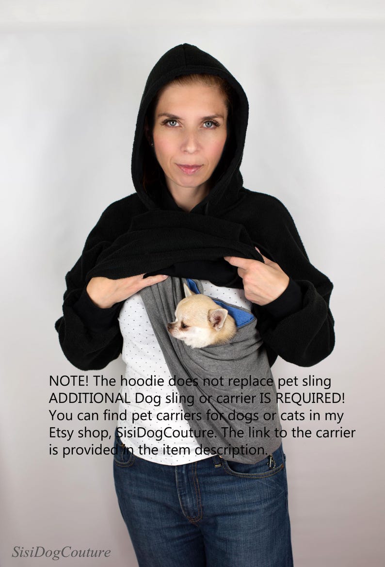 May include: A woman wearing a black hoodie with a gray and blue dog sling inside. The text on the image reads: "NOTE! The hoodie does not replace pet sling ADDITIONAL Dog sling or carrier IS REQUIRED! You can find pet carriers for dogs or cats in my Etsy shop, SisiDogCouture. The link to the carrier is provided in the item description."