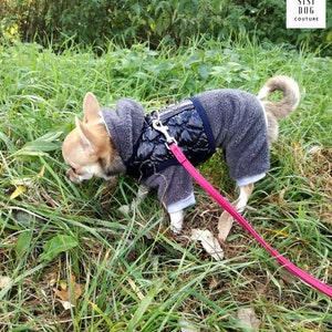 Chihuahua wearing a gray fleece jumpsuit layered with a black quilted vest, ideal for cold walks in nature.