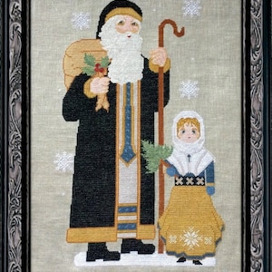 May include: A cross-stitch embroidery of a bearded man in a black robe and a young girl in a white and yellow dress. The man is carrying a sack on his back and a staff in his hand. The girl is holding a small tree. The background is a light beige with snowflakes.