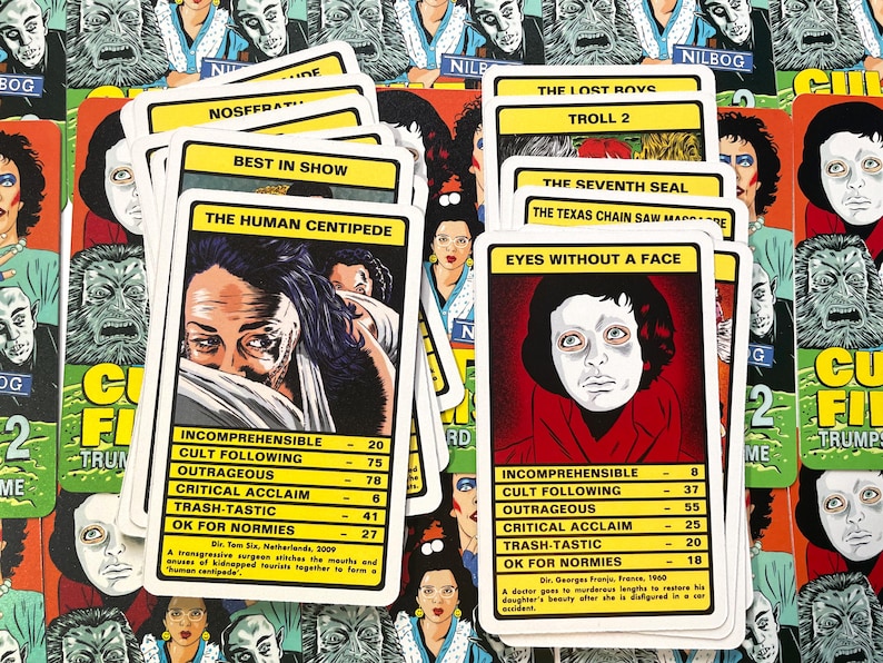 May include: A set of 10 playing cards featuring cult film movie posters. The cards are white with black text and feature titles such as "The Human Centipede", "Eyes Without a Face", "The Lost Boys", and "Troll 2".