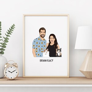 May include: A framed portrait featuring a couple and two cats. The man wears a blue shirt with sunflower patterns. The woman is in a black top. The portrait is labeled "BRIAN & LACY" in black text. The frame is gold.