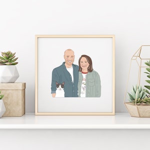 May include: A framed illustration of a couple and a cat. The couple is smiling, and the cat is black and white. The frame is gold, and the artwork is displayed on a white shelf with decorative plants.