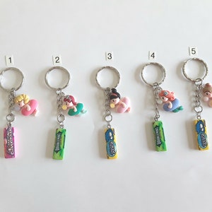 May include: Five keychains featuring different Disney princesses in a swimming pool float. Each keychain has a different flavor of Doublemint gum attached.