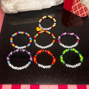 May include: Seven colorful beaded bracelets with different names on each. The names are: "Beelzebub", "Ozzie", "Leviathan", "Satan", "Mammon", "Belphegor", and "Babsmin".