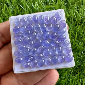 AAA+ tanzaniet cabochons: partij natuurlijke blauwe ovale edelstenen (4 x 6 mm)