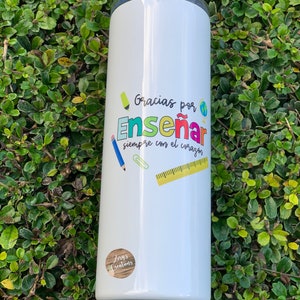 May include: White stainless steel tumbler with a colorful graphic that says "Gracias por Enseñar siempre con el corazón" and a small logo that says "Zeny's Creations".