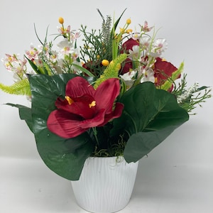 A very elegant arrangement of artificial orchids, flowering petals, fine buds and green textured petals give a realistic look.