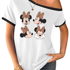 May include: A white ceramic mug with a black handle and the text "But First, Coffee" in a bold, black font. The mug is set against a blurred background, suggesting a cozy setting.