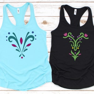 May include: Two tank tops with a stylized floral design. One tank top is light blue with a teal, purple, and red design. The other tank top is black with a green, purple, and yellow design.