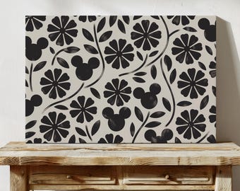 May include: A rectangular canvas print featuring a repeating pattern of black flowers and black Mickey Mouse silhouettes on a light beige background. The design includes thin black stems and leaves interspersed between the floral and character shapes.