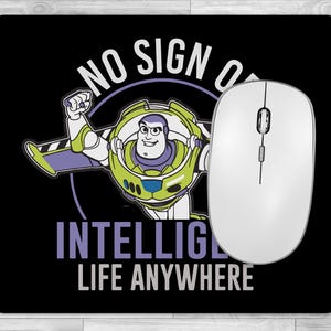 May include: A black mouse pad with a green and purple cartoon character of Buzz Lightyear from the movie Toy Story. The text on the mouse pad reads "No sign of intelligence life anywhere".