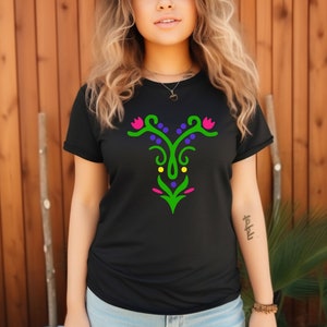 May include: Black t-shirt with a green, purple, yellow, and pink floral design on the front.