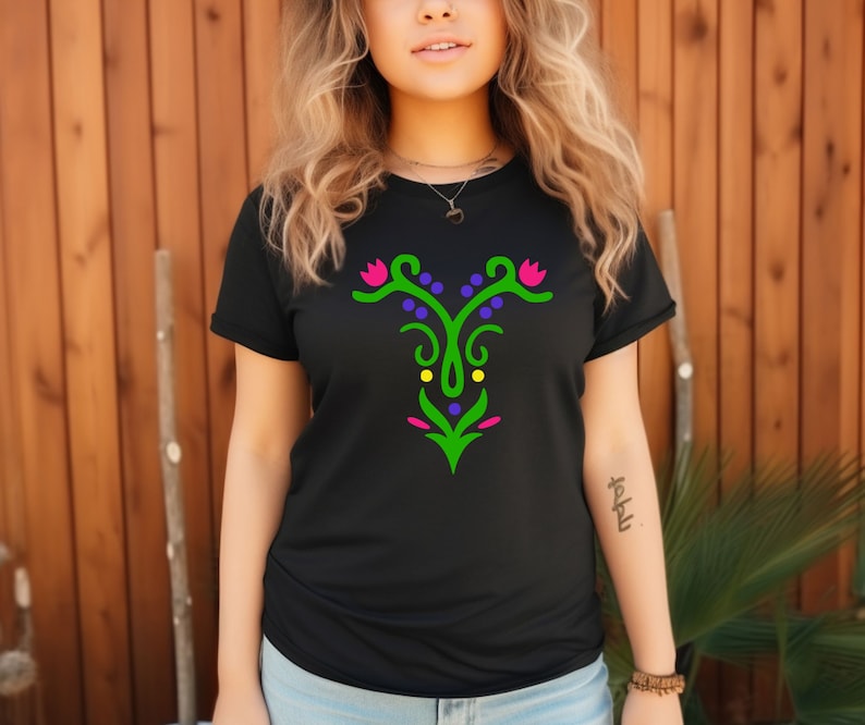 May include: Black t-shirt with a green, purple, yellow, and pink floral design on the front.