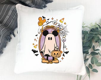 May include: White square pillow with a Halloween-themed design. The design features a cartoon ghost wearing Mickey Mouse ears, holding a jack-o'-lantern, and the word "Spooky". Includes bats, candy corn, and stars.