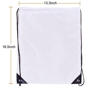 May include: A white drawstring backpack featuring black cords and black reinforced corners with metal grommets. The bag measures 33.8 cm in width and 41.9 cm in height as indicated by the visible measurement lines and text labels.
