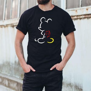 May include: Black t-shirt featuring a white outline of Mickey Mouse with red and yellow accents. The design is a minimalist illustration of the iconic cartoon character. The shirt is a classic crew neck style.