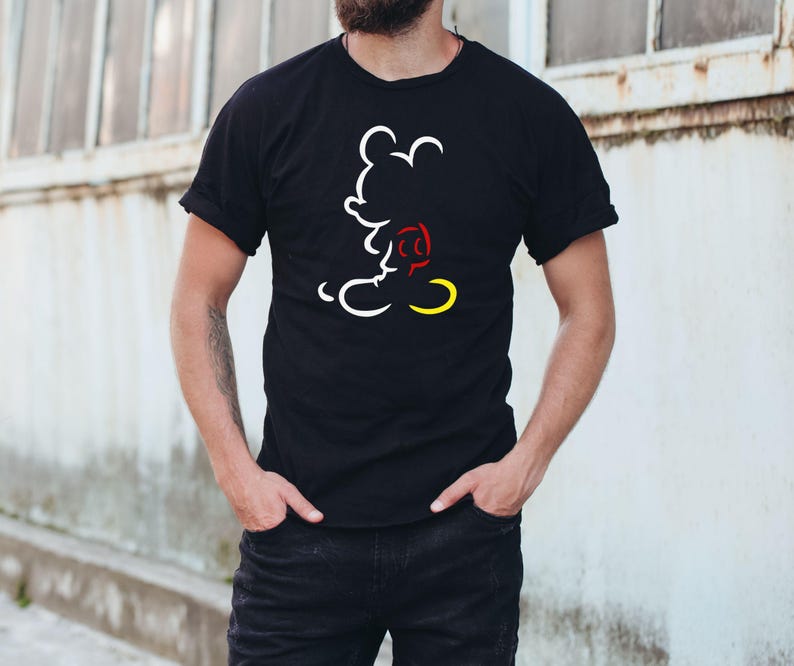 May include: Black t-shirt featuring a white outline of Mickey Mouse with red and yellow accents. The design is a minimalist illustration of the iconic cartoon character. The shirt is a classic crew neck style.