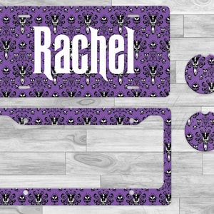 May include: A white ceramic mug with a black handle and the text "But First, Coffee" in a bold, black font. The mug is set against a blurred background, suggesting a cozy setting.