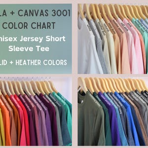 May include: Color chart of Bella + Canvas 3001 unisex jersey short sleeve tees in solid and heather colors. The image displays a variety of colors, including white, pink, blue, green, and black, hanging on wooden hangers.