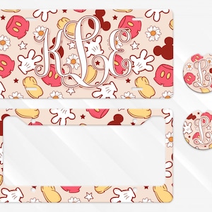 May include: A license plate, license plate frame, and car coasters with a repeating pattern of Mickey Mouse gloves, ears, and shoes in red, yellow, and white on a beige background. A monogram is centered on the license plate.