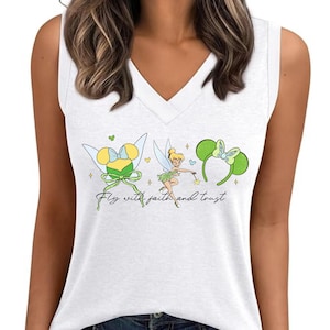 May include: White V-neck tank top featuring a cartoon design of Tinkerbell and Minnie Mouse ears. The design includes the text "Fly with faith and trust". The tank top is sleeveless and made of a soft material.