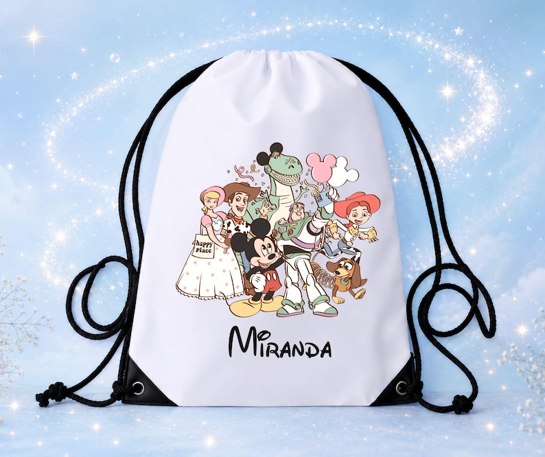 May include: A white drawstring backpack featuring a graphic print of Mickey Mouse, Buzz Lightyear, Woody, Jessie, Rex, Slinky Dog, and Bo Peep. The characters are holding balloons, and the name Miranda is printed in black text below the illustration.